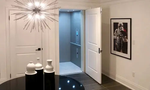 Residential elevator installed in a modern home with Star Wars artwork on the wall.