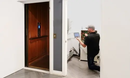 Elevator technician working on configuring the home elevator in the machine room.