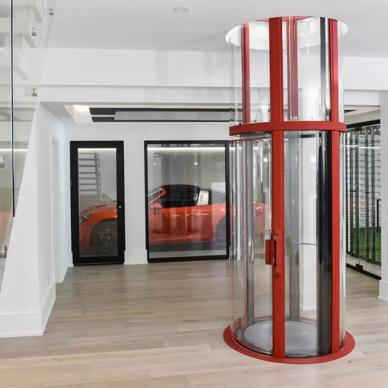 Red framed panoramic elevator paired with a luxurious red sports car in the garage.