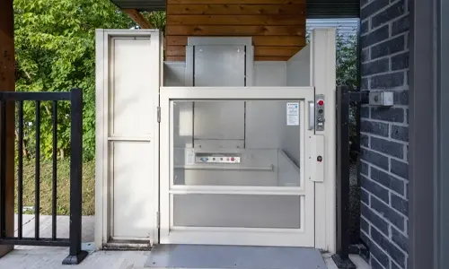 A standard beige Savaria V-1504 installed outside of a residential setting for easy home accessibility.