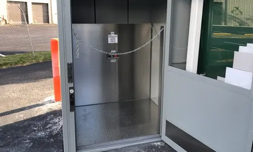 A Savaria M-1504 material lift that can be accessed from the exterior of a commercial building.