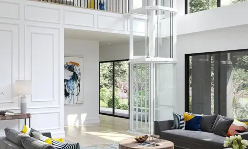 A glass octagonal glass panoramic elevator in the living room, with white frame.