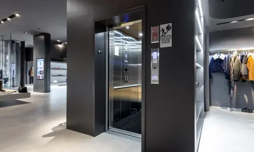 Limited use and limited application stainless steel elevator installed in a retail setting.