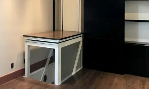 A Telecab17 through the floor lift in the corner of a house descending into the lower level.