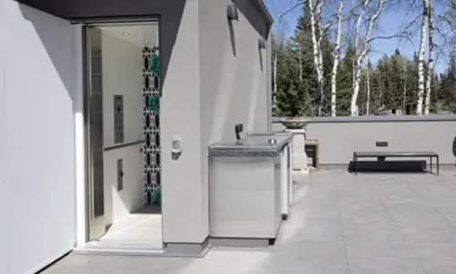 An interior Vertical Platform Lift providing accessibility to a terrace