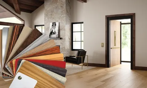 Luxury MDF finish samples displayed in a fanned layout over a modern home interior with an open elevator.