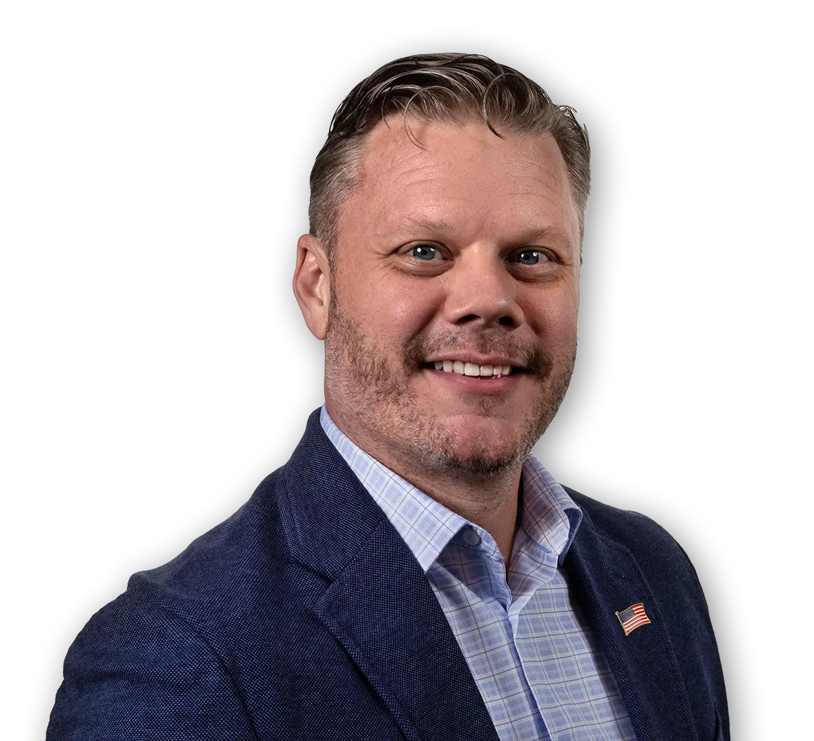 Regional sales manager in charge of Veteran Affairs wearing a blue blazer and checkered shirt with a small American flag pin on the lapel.