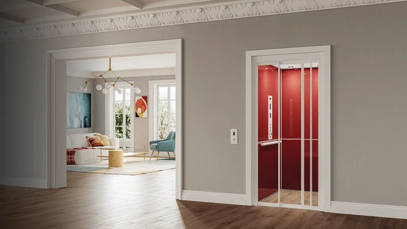 Modern residential home featuring a bright red elevator cab with slim glass doors.