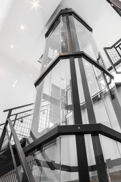 Cover image showing a glass panoramic home elevator with black framing, overlaid with the title ‘Introduction to Winding Drum Panoramic Home Elevators.'