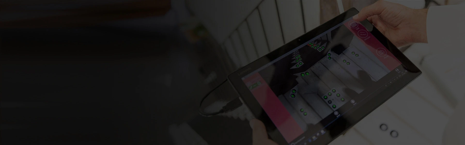 Tablet displaying a stairlift diagnostic interface held by a technician.