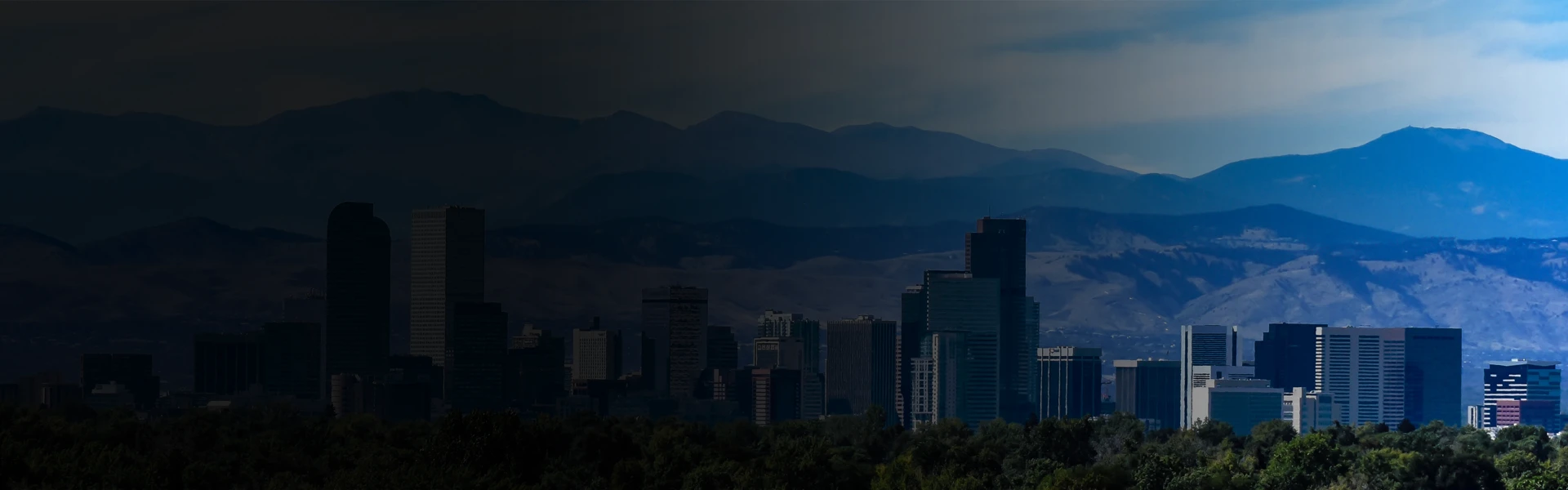 Denver, Colorado skyline with downtown buildings set against the Rocky Mountains