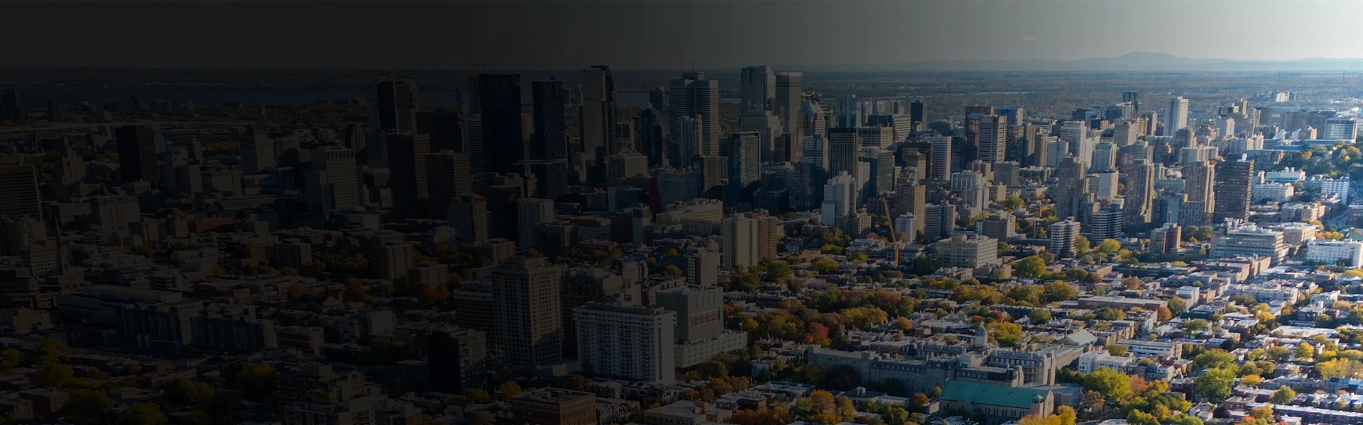 Quebec City skyline with dense urban buildings and autumn foliage viewed from above