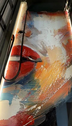 Abstract mural of a face with bold brushstrokes painted inside of a home elevator shaft.