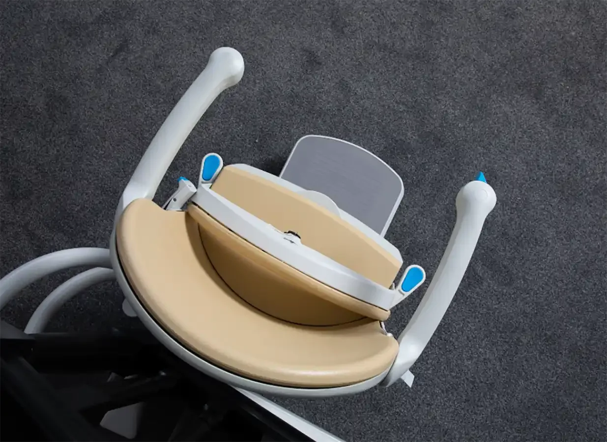 Savaria Handicare 4000 twin-rail curved stairlift with Simplicity Seat in sand upholstery, folded armrests and seat, compact 16.25-inch profile viewed from above