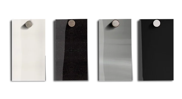 Four steel finish samples for a commercial elevator, shown in architectural white, black, blackened stainless steel and stainless steel.
