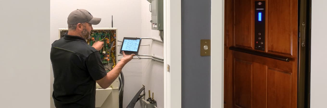 elevator technician working on elevator